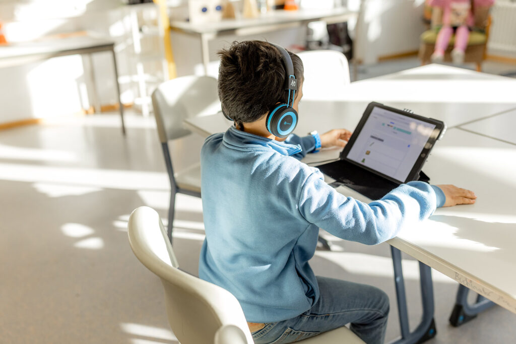 Kind arbeitet mit Tablet im Unterricht